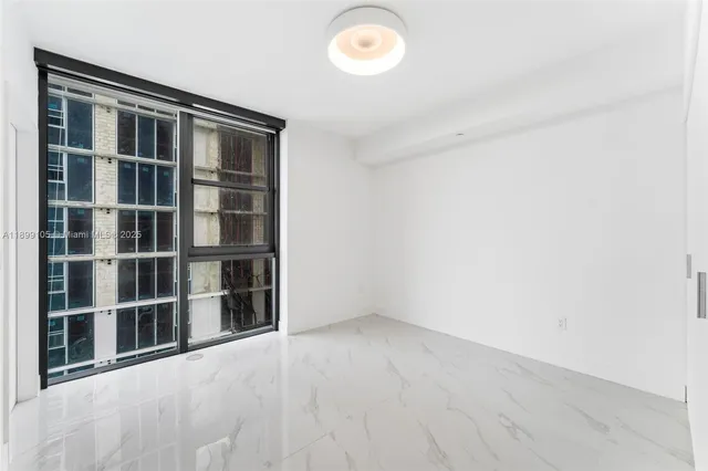 a balcony with furniture and a potted plant