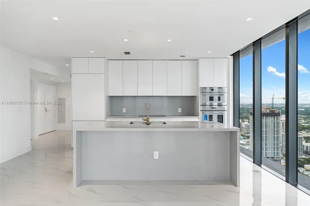 an empty room with a kitchen and a sink