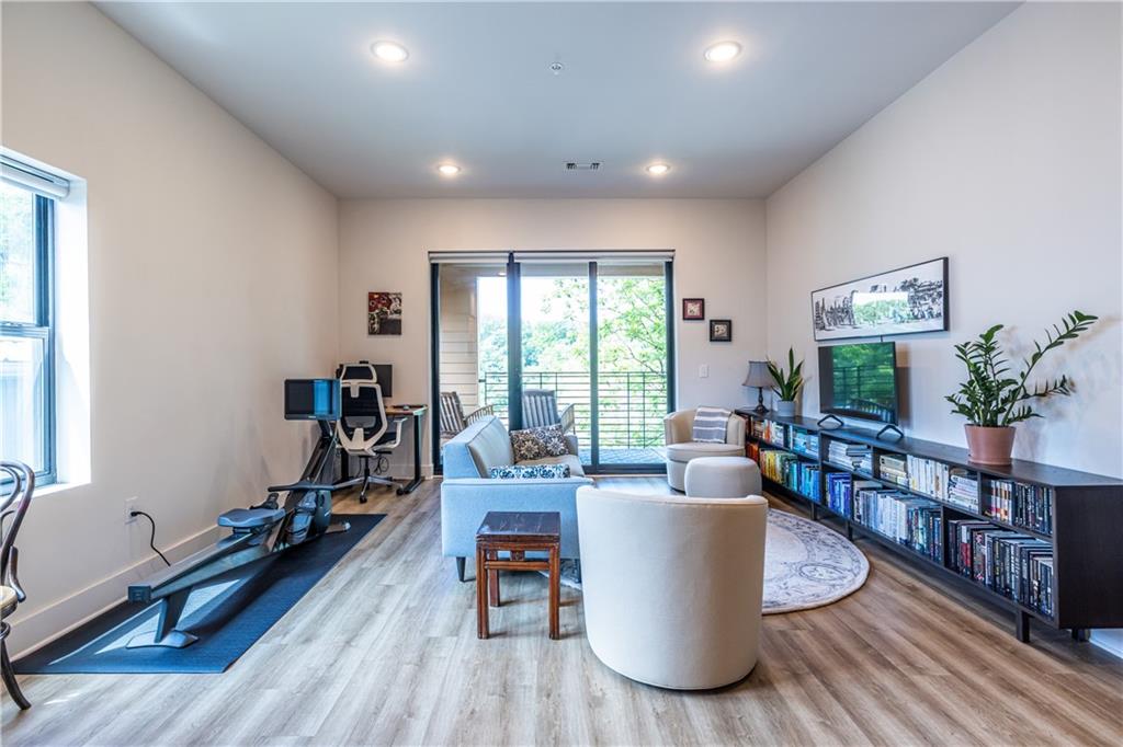 112 Rogers Street Southeast, Unit 208 Atlanta, GA 30307 - Photo 13 of 44 a living room with furniture and a wooden floor