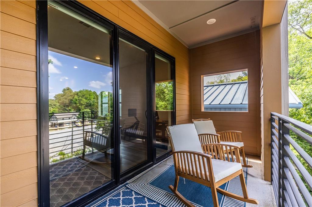 112 Rogers Street Southeast, Unit 208 Atlanta, GA 30307 - Photo 16 of 44 a view of a balcony with chairs