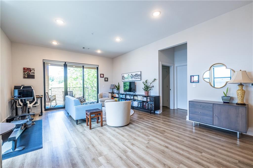 112 Rogers Street Southeast, Unit 208 Atlanta, GA 30307 - Photo 20 of 44 a living room with furniture and a wooden floor