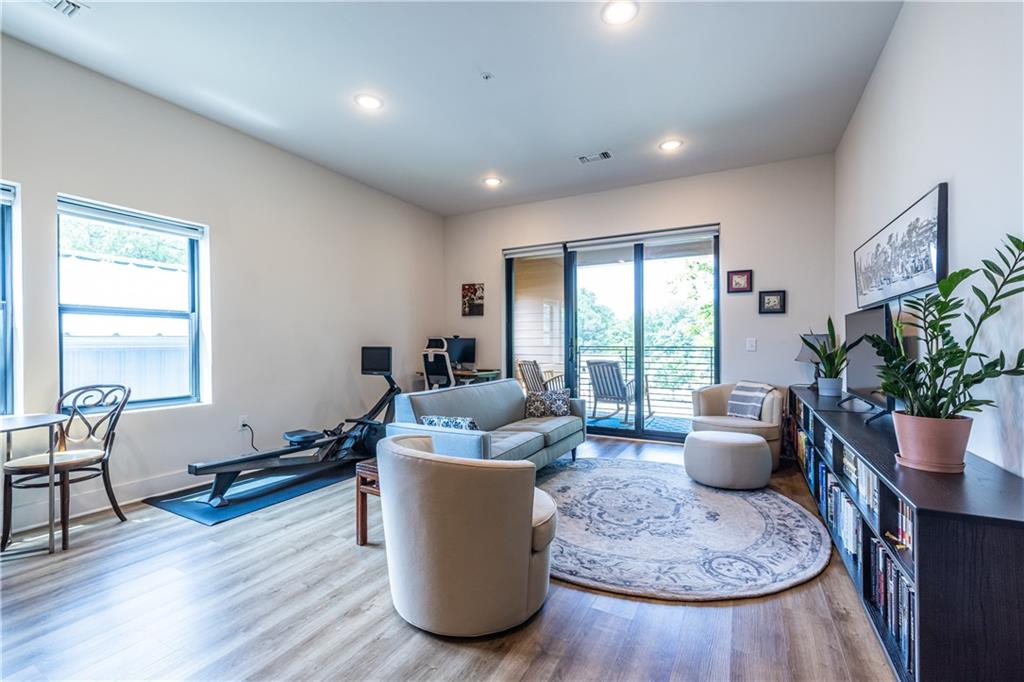 112 Rogers Street Southeast, Unit 208 Atlanta, GA 30307 - Photo 22 of 44 a living room with furniture and a potted plant