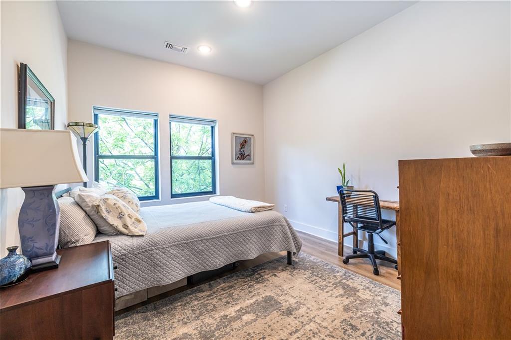 112 Rogers Street Southeast, Unit 208 Atlanta, GA 30307 - Photo 23 of 44 a bedroom with a bed and a window