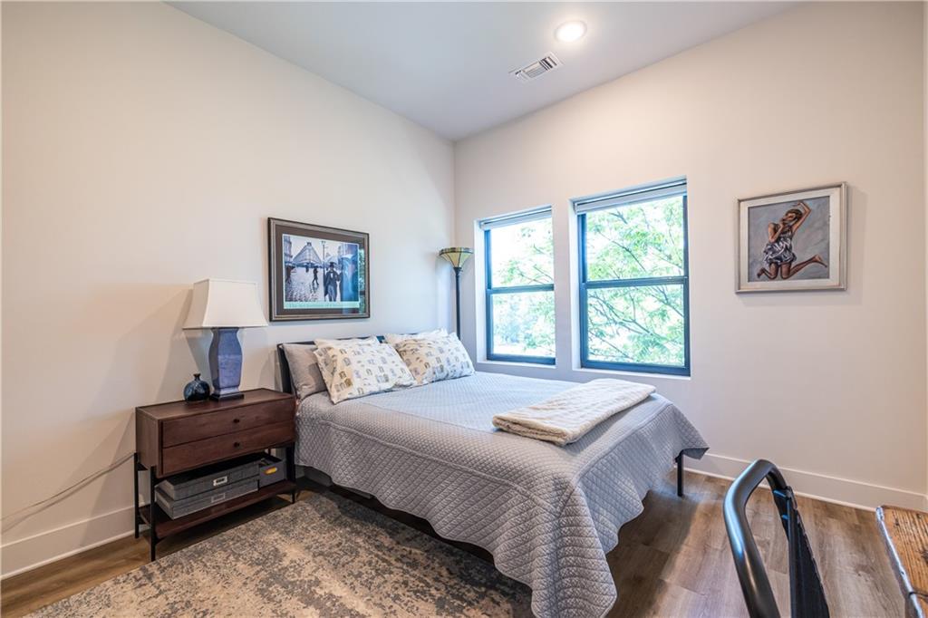 112 Rogers Street Southeast, Unit 208 Atlanta, GA 30307 - Photo 24 of 44 a bedroom with a bed and a window