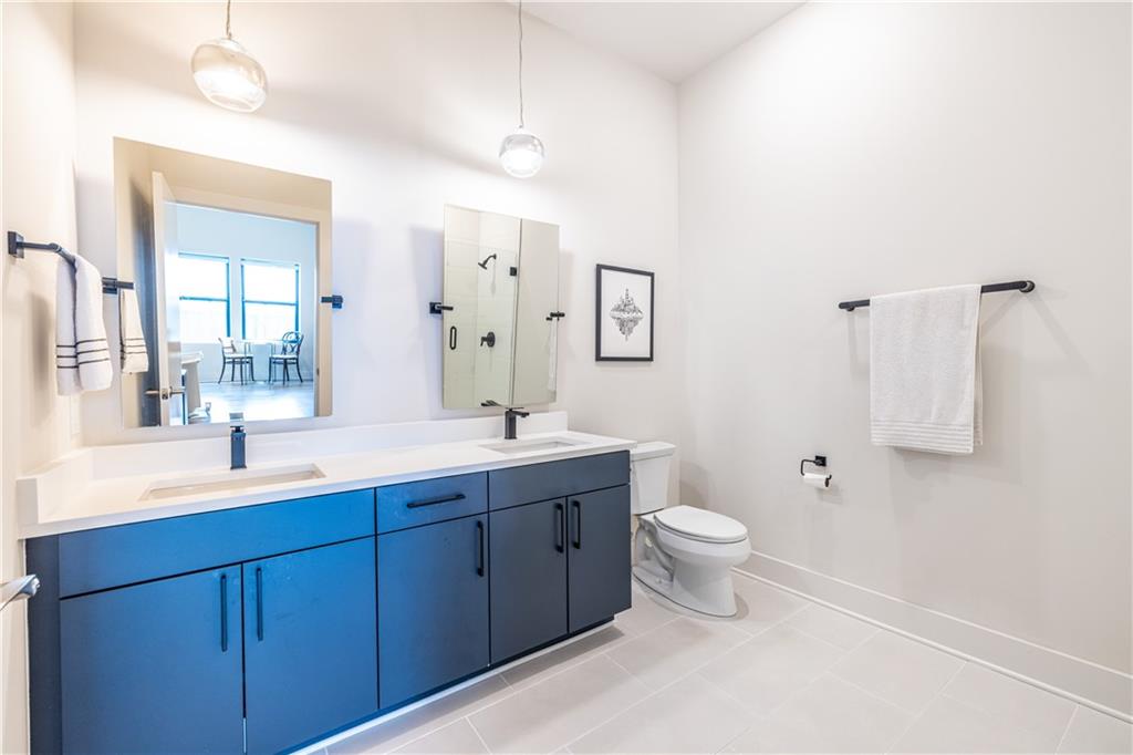 112 Rogers Street Southeast, Unit 208 Atlanta, GA 30307 - Photo 26 of 44 a bathroom with a double vanity sink toilet and a mirror