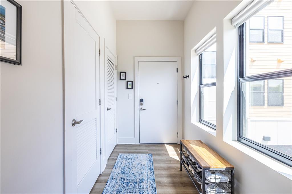 112 Rogers Street Southeast, Unit 208 Atlanta, GA 30307 - Photo 28 of 44 a view of an entryway with wooden floor and a bedroom