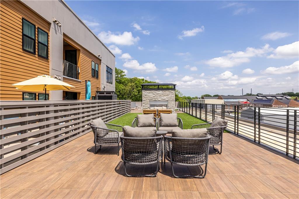 112 Rogers Street Southeast, Unit 208 Atlanta, GA 30307 - Photo 35 of 44 a roof deck with table and chairs