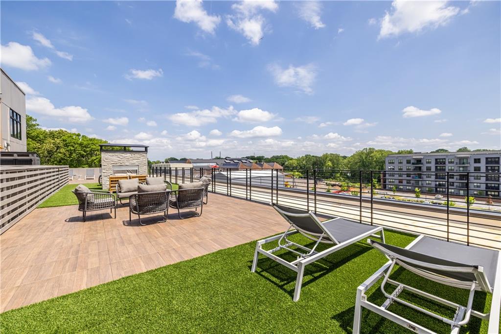 112 Rogers Street Southeast, Unit 208 Atlanta, GA 30307 - Photo 38 of 44 an outdoor sitting area with couch and a garden