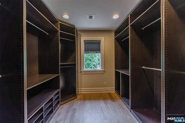 a bathroom with a granite countertop sink a toilet a mirror and vanity