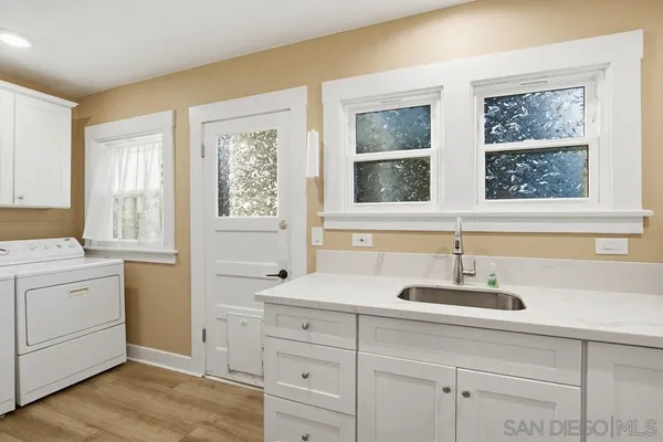 a view with cabinets a sink and dishwasher in it
