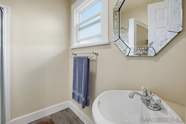 a bathroom with a glass shower door