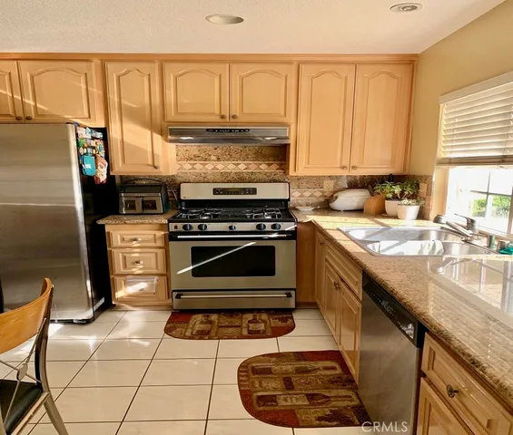 a kitchen with a stove a sink and a refrigerator