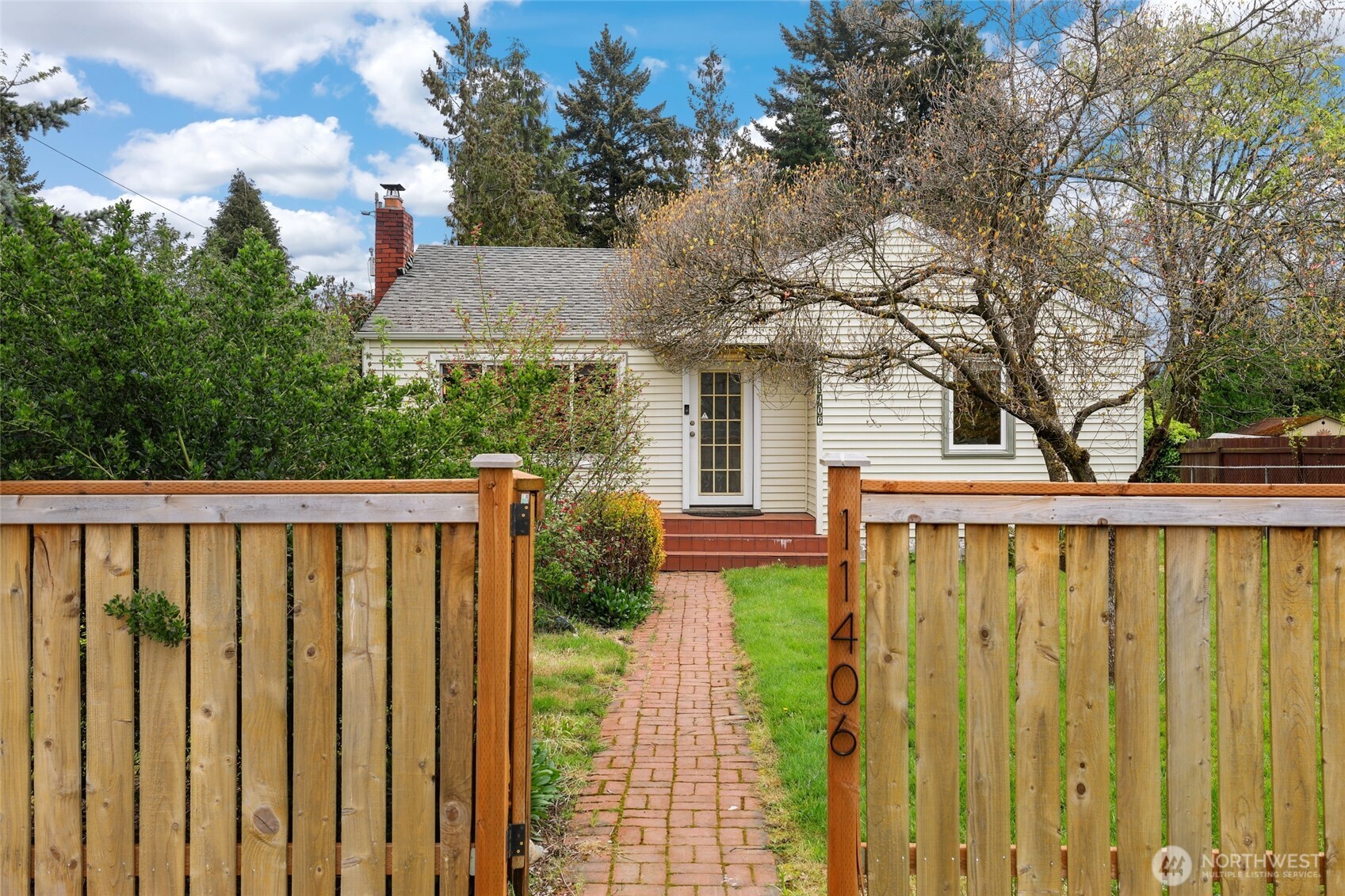11406 12th Avenue Southwest Seattle, WA 98146 - Photo 1 of 30 a view of a house with a wooden fence