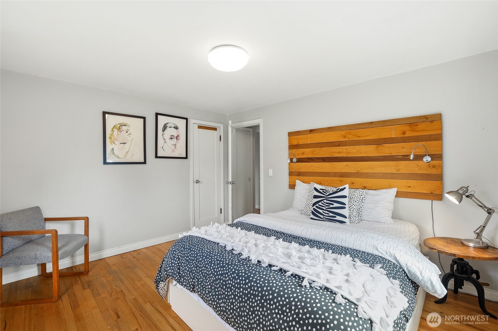 11406 12th Avenue Southwest Seattle, WA 98146 - Photo 14 of 30 a bedroom with a bed and wooden floor
