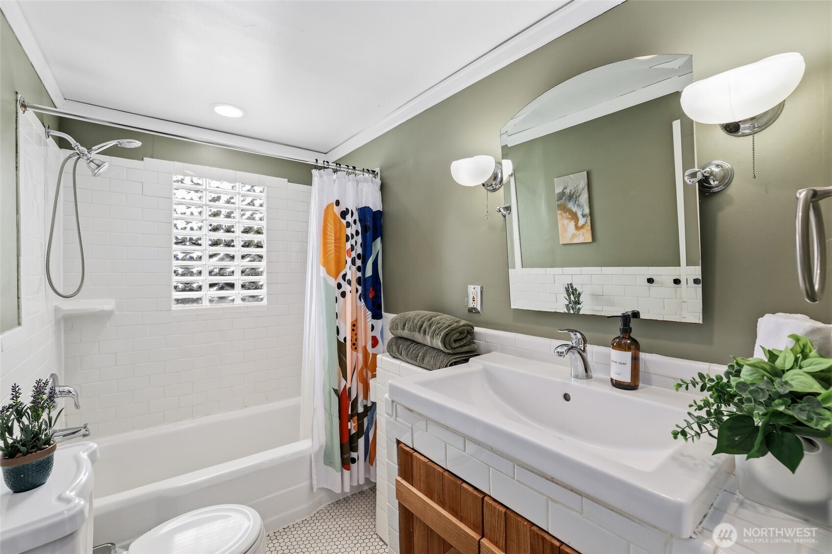 11406 12th Avenue Southwest Seattle, WA 98146 - Photo 15 of 30 a bathroom with a sink tub shower and a mirror