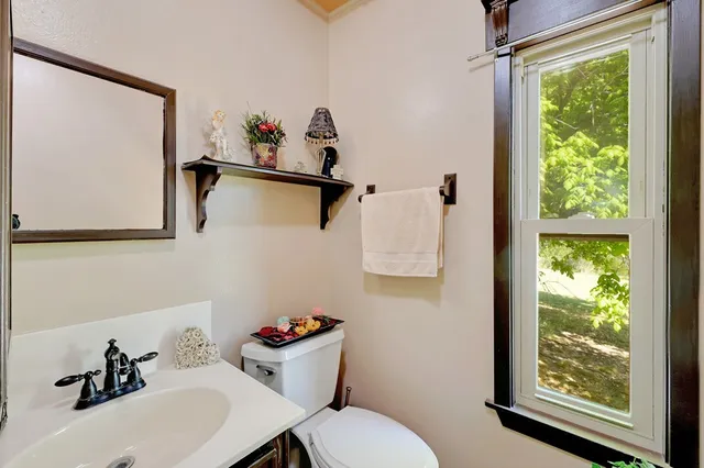 a bathroom with a sink mirror and toilet