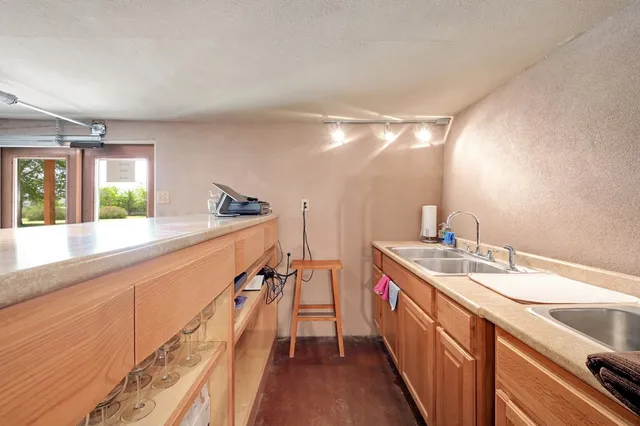 a kitchen with a sink and refrigerator