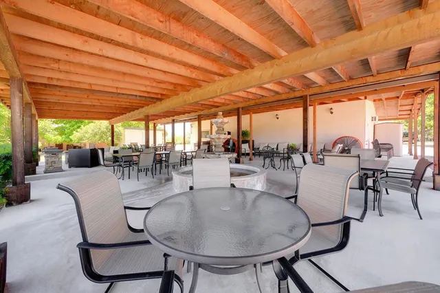 a dining room with furniture garden view and a chandelier