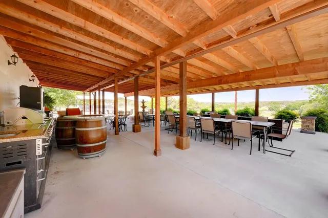 a view of a patio with a table and chairs