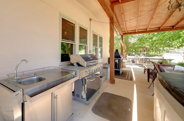 a kitchen with stainless steel appliances granite countertop a sink and a stove