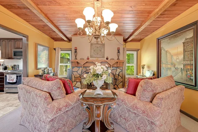 a living room with furniture a chandelier and a chandelier