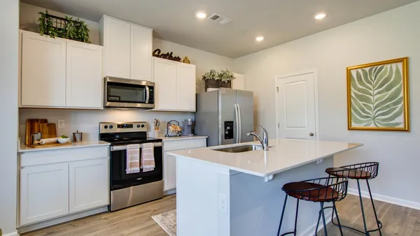 a kitchen with stainless steel appliances a stove refrigerator sink and cabinets
