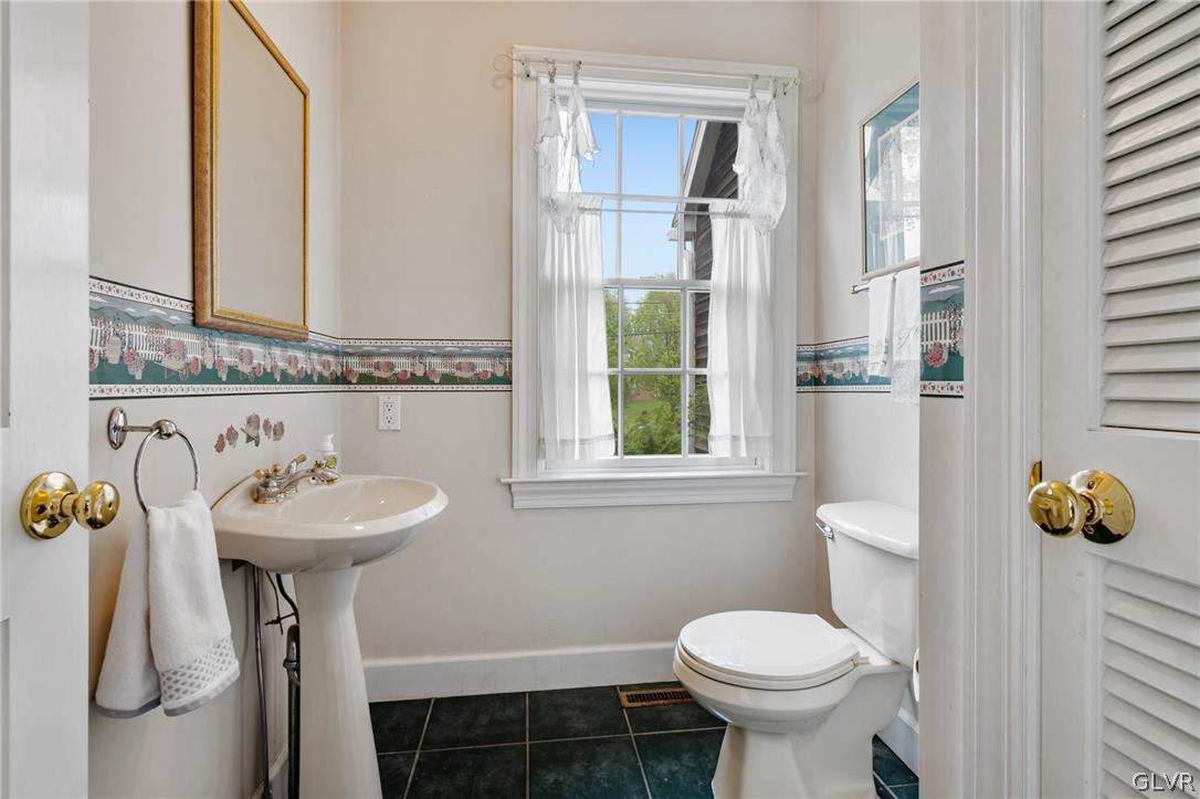 4236 Huckleberry Road Allentown, PA 18104 - Photo 25 of 39 a bathroom with a sink toilet and a mirror