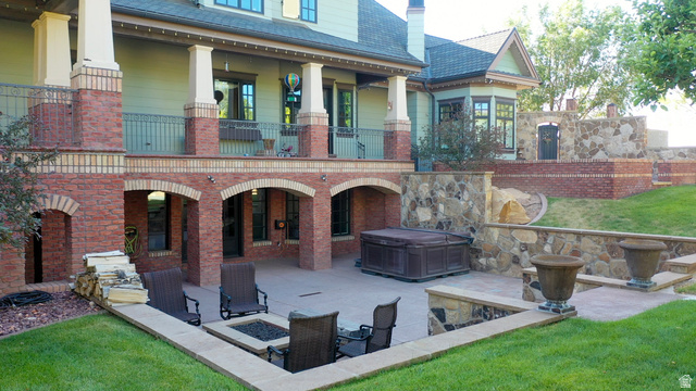 426 West Center Street Parowan, UT 84761 - Photo 81 of 107 Multi-level outdoor living space featuring a covered patio with brick archways, a ground-level concrete patio, and a built-in fire pit area