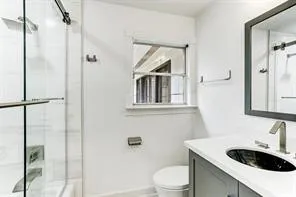 a bathroom with a sink toilet and shower