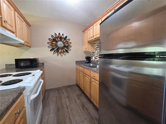 a kitchen with sink cabinets and wooden floor