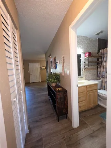 a view of a living room kitchen and a wooden floor