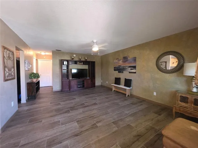 a view of a livingroom with furniture and an empty room