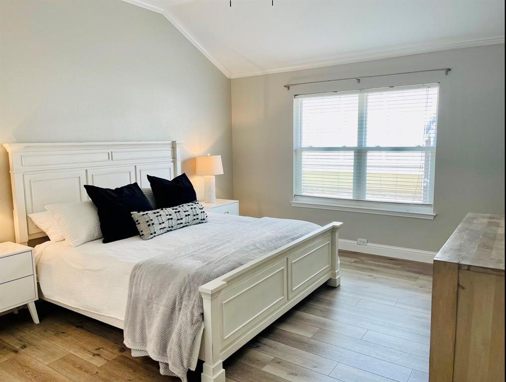 7848 Lancelot Road Frisco, TX 75035 - Photo 18 of 27 a bedroom with a bed and a window