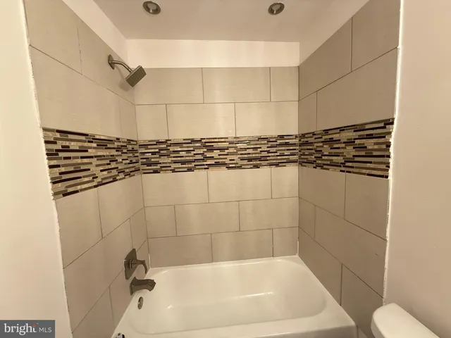 a bathroom with a bathtub and shower