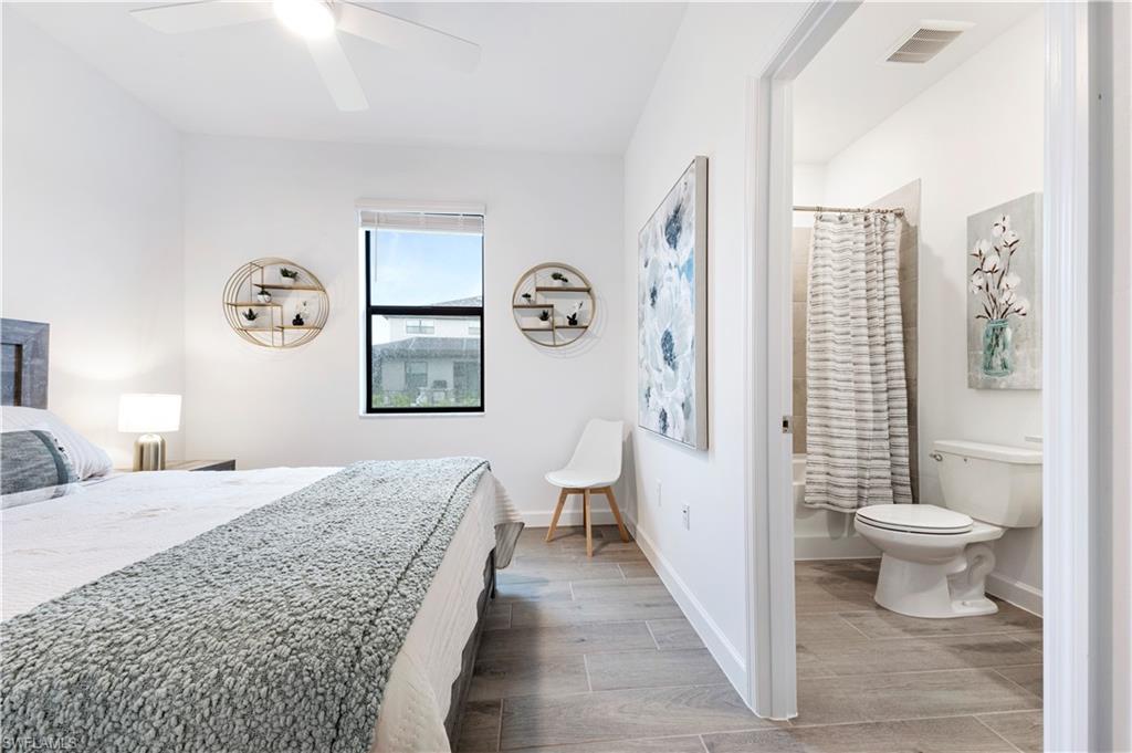 11096 Canopy Loop Fort Myers, FL 33913 - Photo 15 of 21 a bedroom with a bed and a view of bathroom