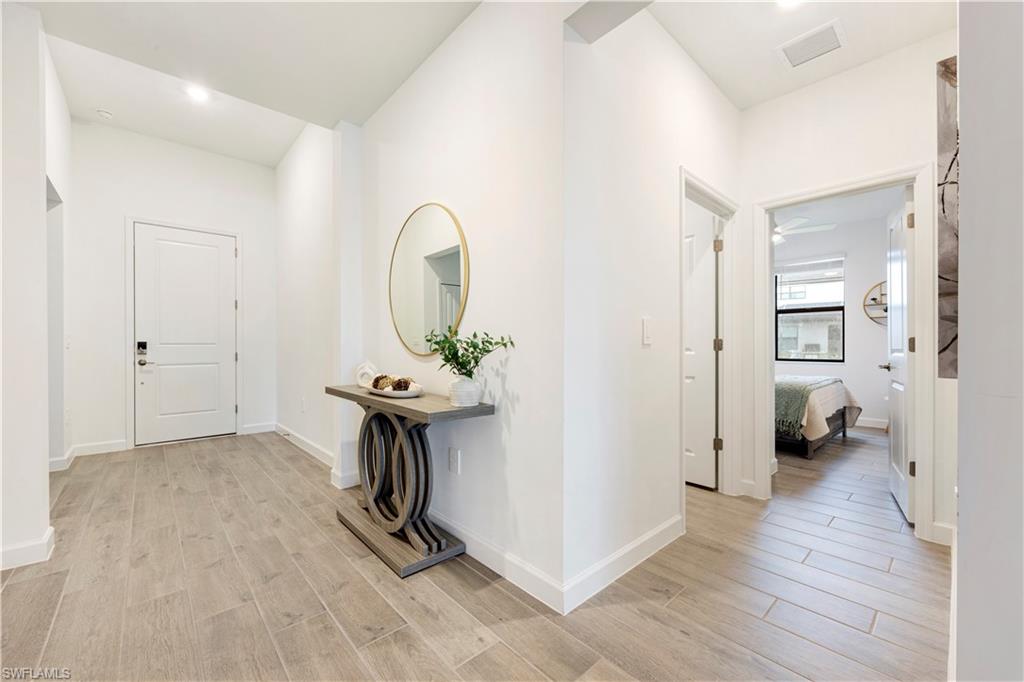 11096 Canopy Loop Fort Myers, FL 33913 - Photo 4 of 21 a view of a livingroom with wooden floor and a bathroom