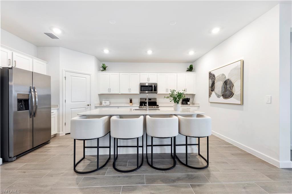 11096 Canopy Loop Fort Myers, FL 33913 - Photo 7 of 21 a white kitchen with a sink cabinets and stainless steel appliances