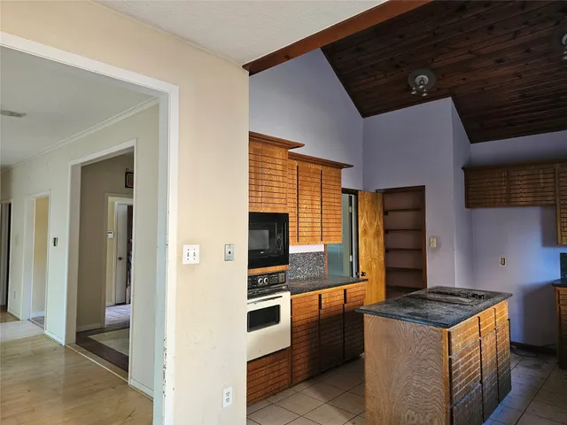 a kitchen with stainless steel appliances granite countertop a stove and a refrigerator