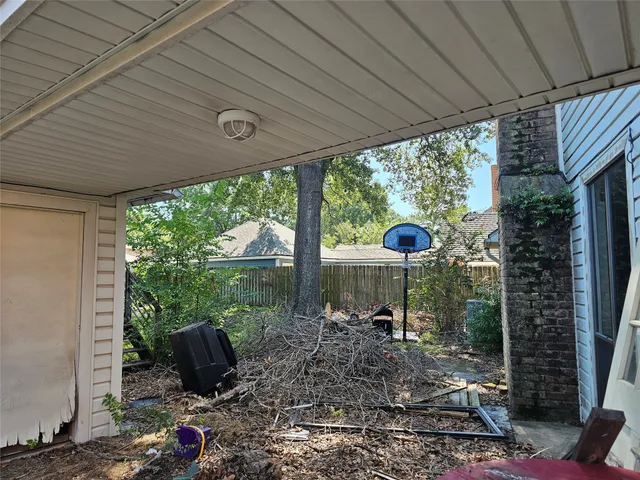 a view of a porch with furniture and a backyard