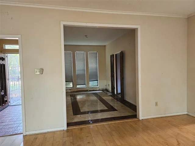 hallway with view of wooden floor