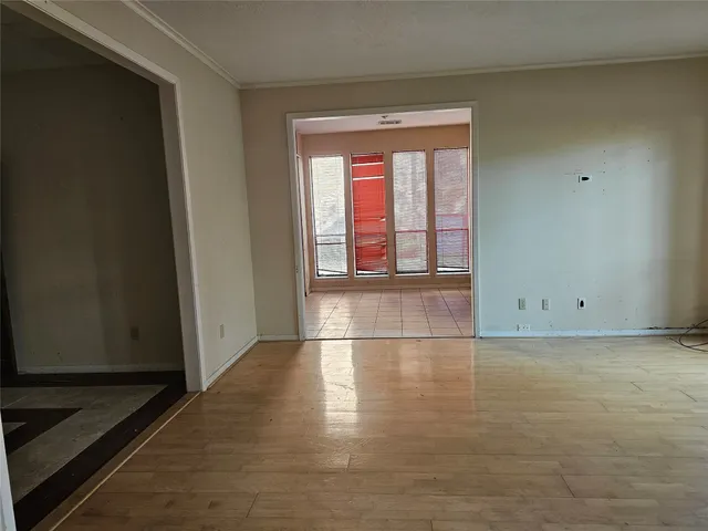 a view of wooden floor and windows in a room