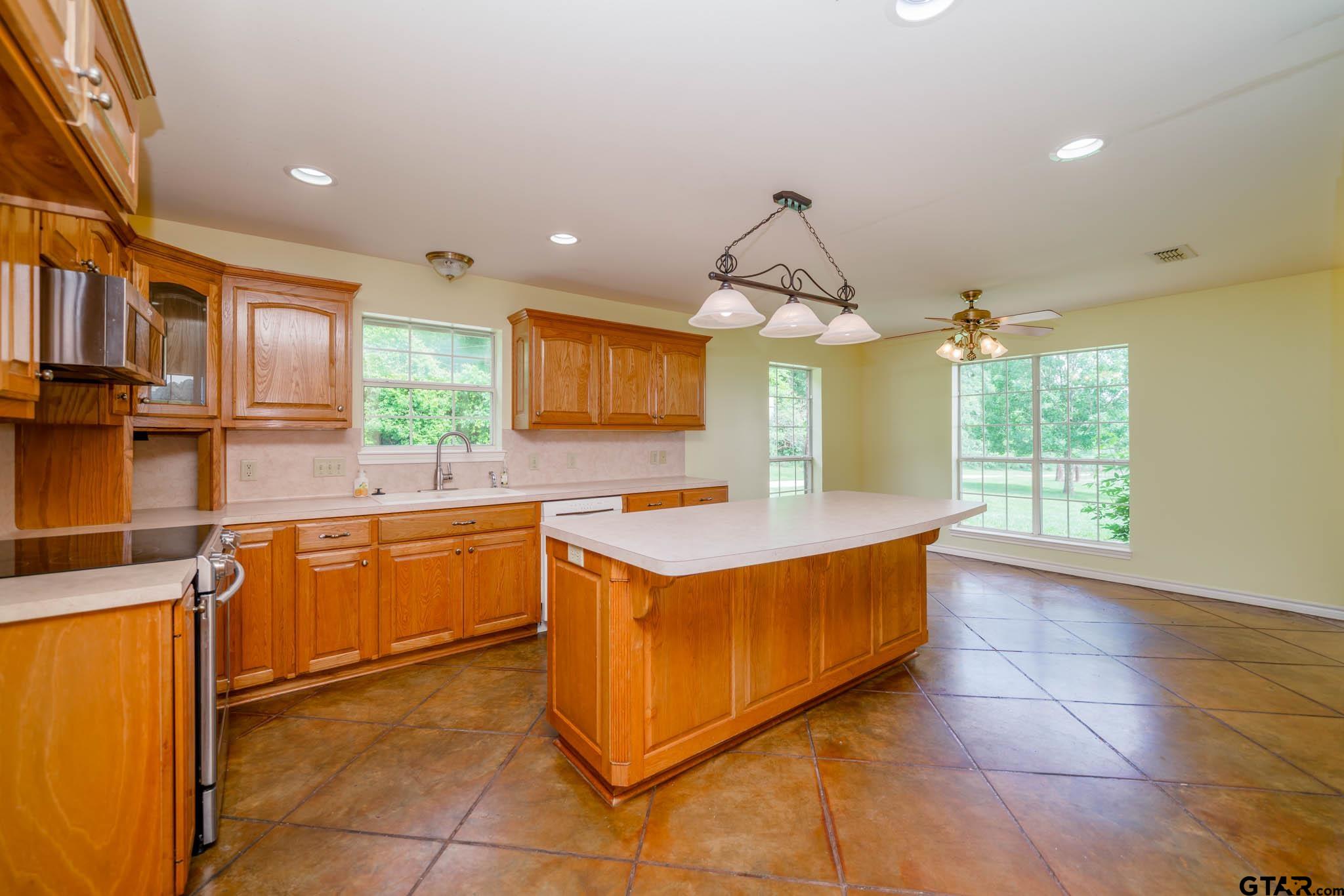 3460 Hawk Road Diana, TX 75640 - Photo 15 of 40 a kitchen with stainless steel appliances granite countertop a sink and a stove