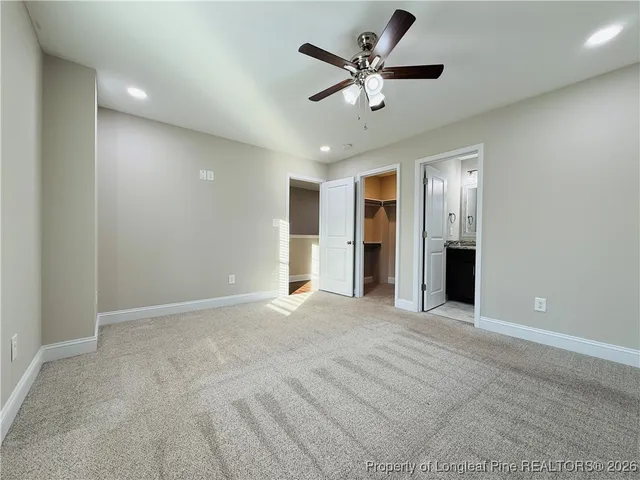 a view of an empty room with a ceiling fan