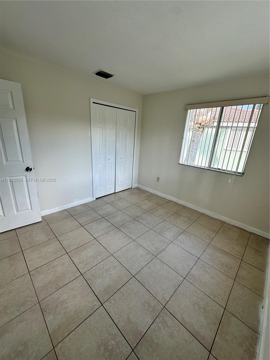 1529 Southeast 24th Court, Unit 233 Homestead, FL 33035 - Photo 13 of 35 an empty room with windows