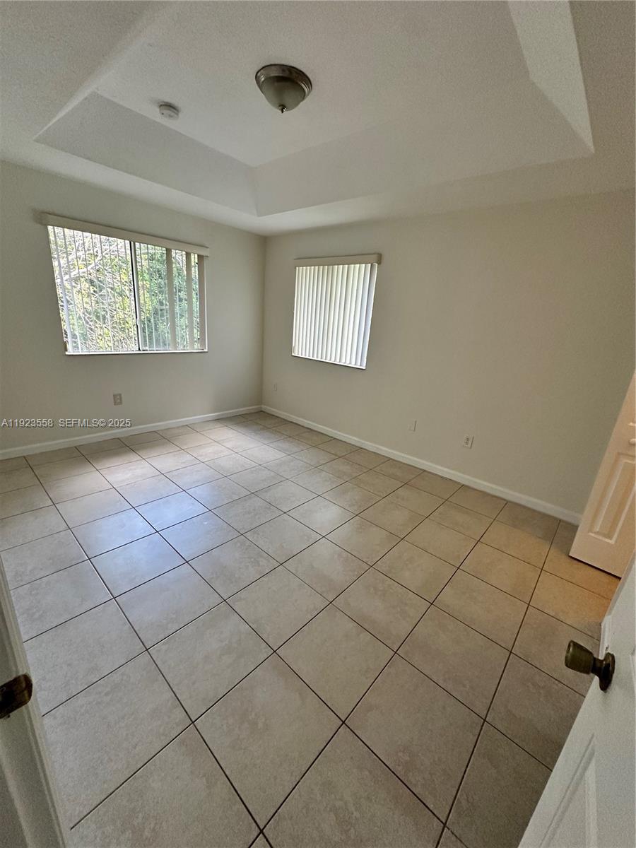 1529 Southeast 24th Court, Unit 233 Homestead, FL 33035 - Photo 23 of 35 an empty room with windows