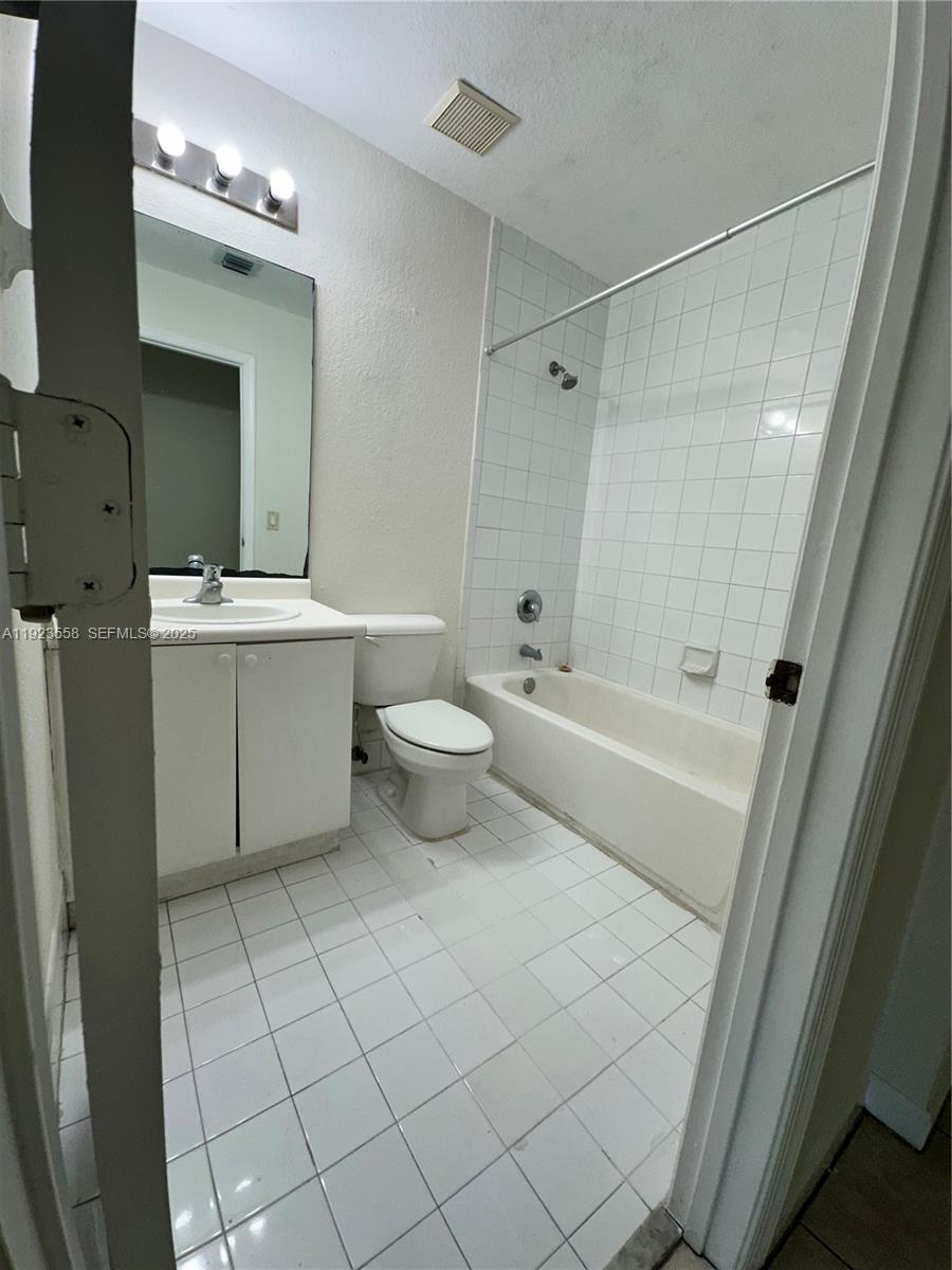 1529 Southeast 24th Court, Unit 233 Homestead, FL 33035 - Photo 25 of 35 a bathroom with a sink a toilet and shower