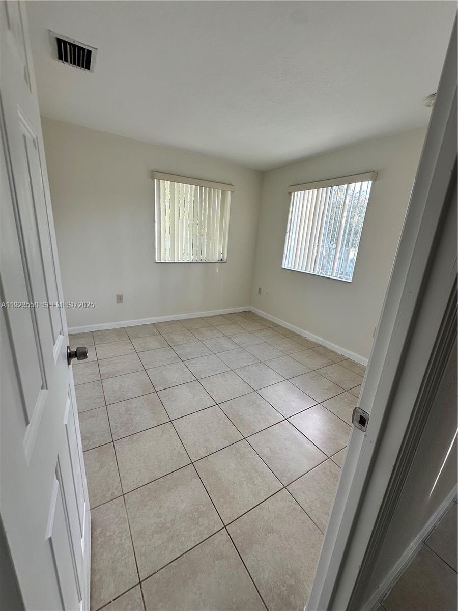 1529 Southeast 24th Court, Unit 233 Homestead, FL 33035 - Photo 26 of 35 an empty room with windows