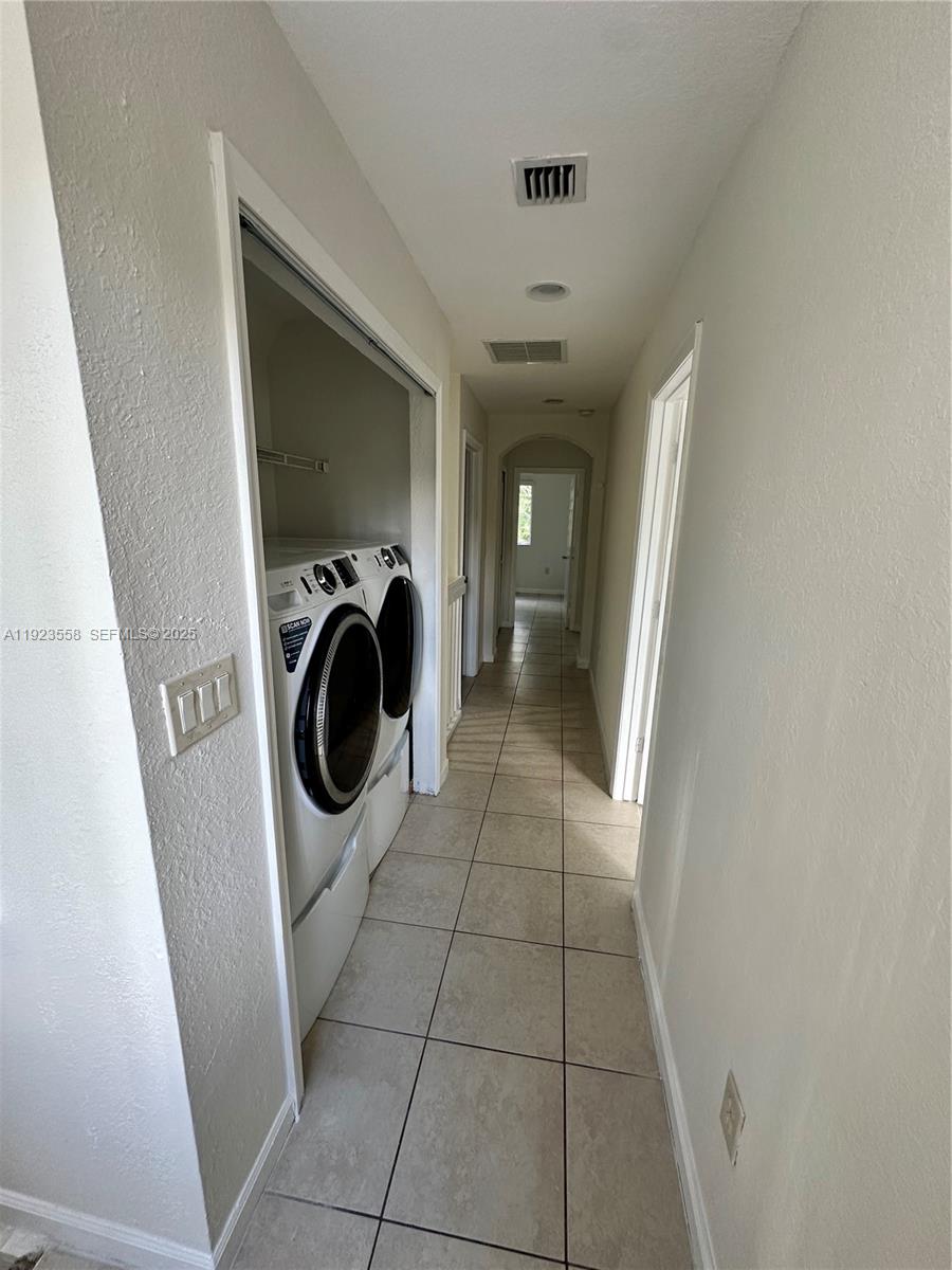 1529 Southeast 24th Court, Unit 233 Homestead, FL 33035 - Photo 28 of 35 a utility room with dryer and washer