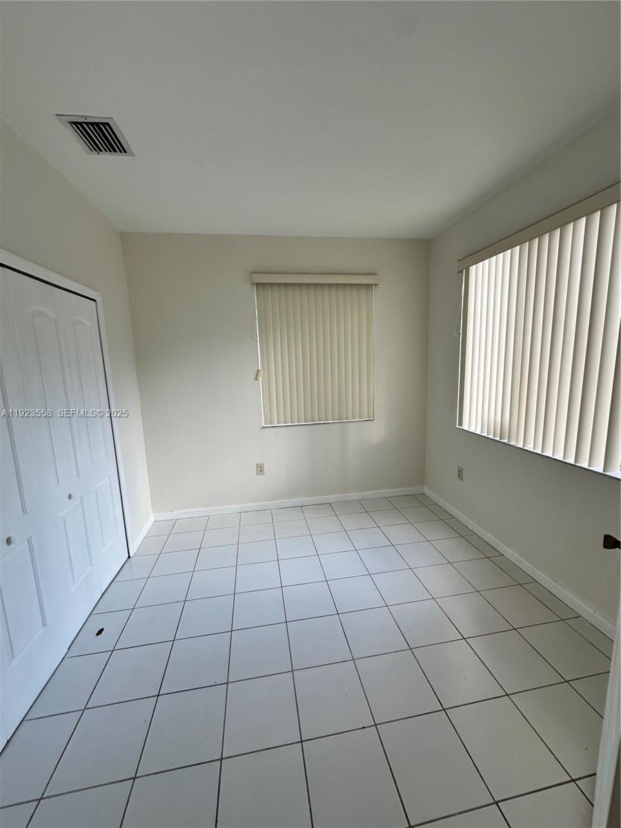1529 Southeast 24th Court, Unit 233 Homestead, FL 33035 - Photo 29 of 35 a view of an empty room and window