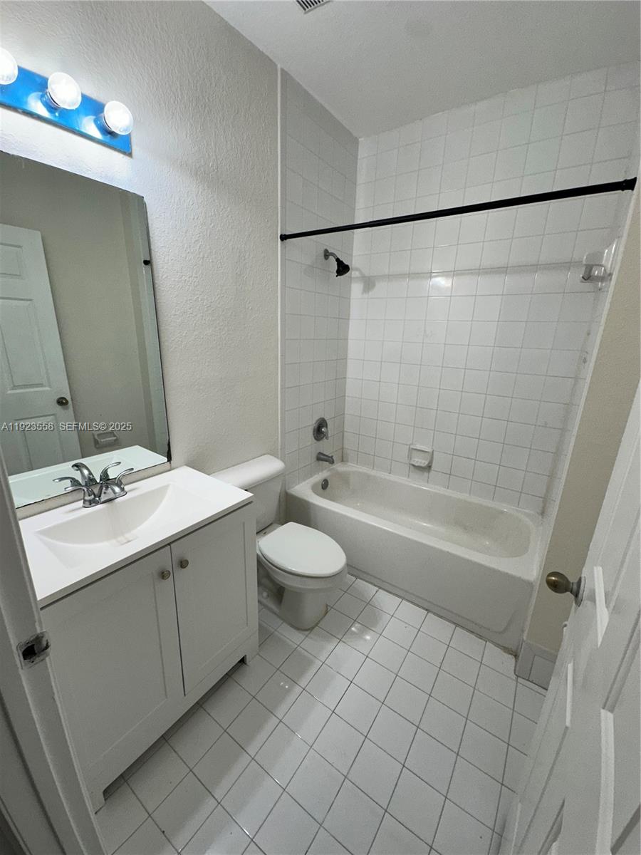 1529 Southeast 24th Court, Unit 233 Homestead, FL 33035 - Photo 30 of 35 a bathroom with a sink a toilet and shower